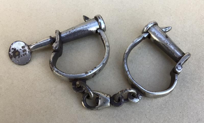 A Vintage Set of Turn Key Hand Cuffs